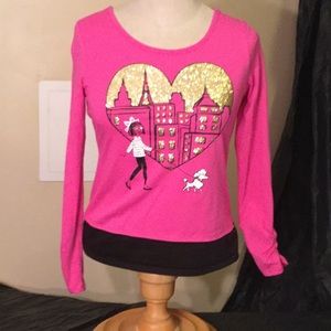 A pink and black shirt with gold glitter